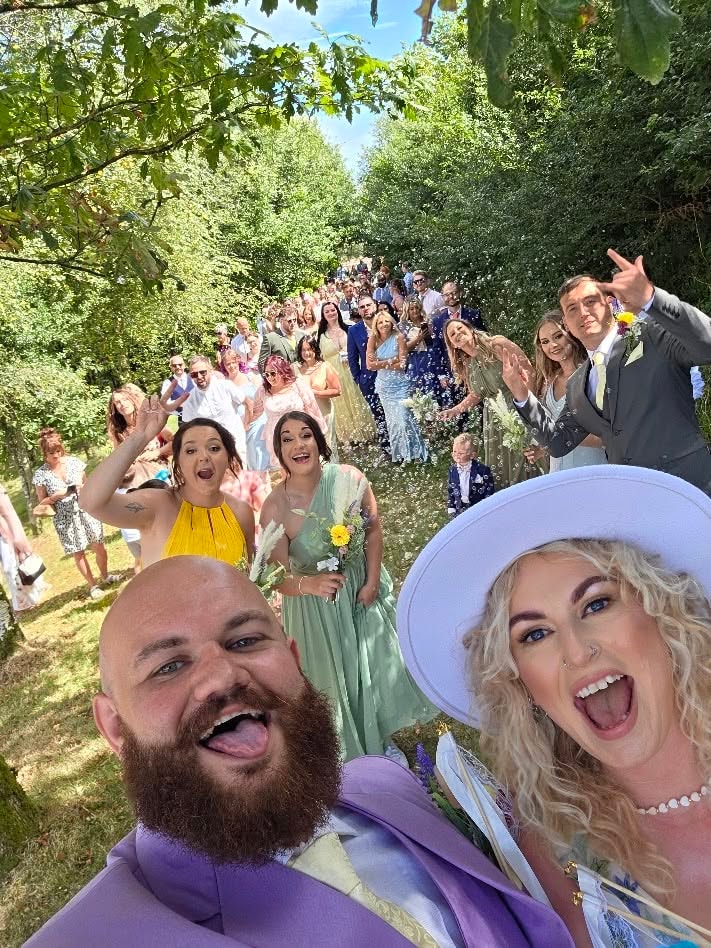 Wedding party celebrating together in the woodland at Oak Tree Farm