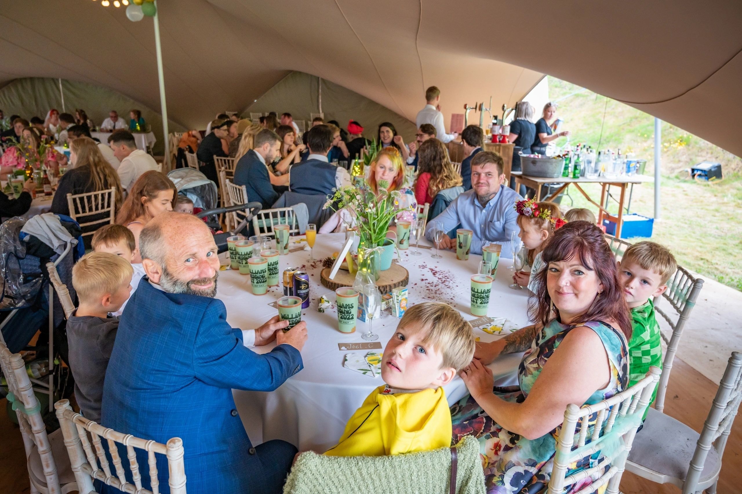Stretch tent wedding reception with warm lighting